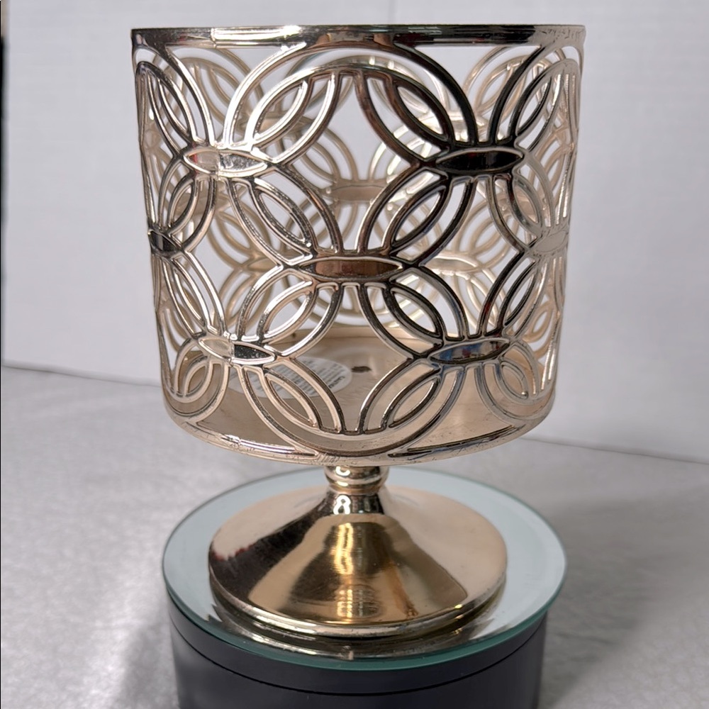 Bath & body Works candle holder rose gold holds a three wick candle